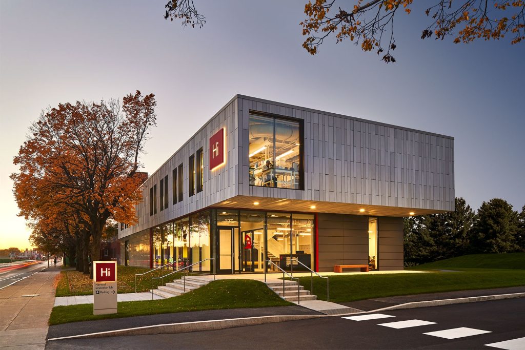 Finished permanent modular building with cantilevered design, photographed at blue hour