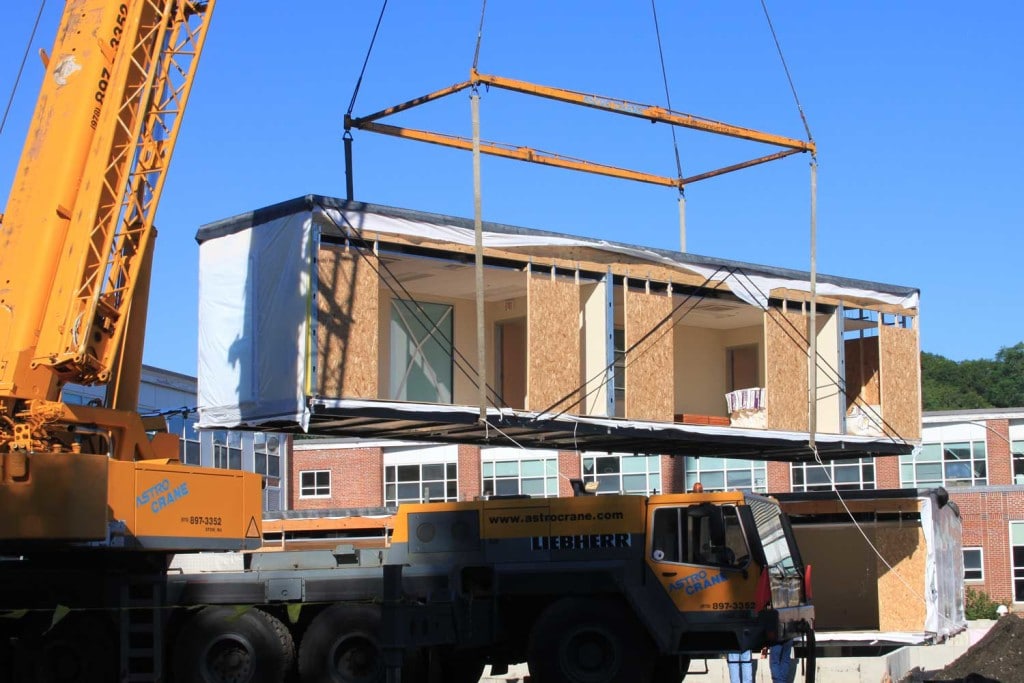 A crane placing modular units in the right spot.