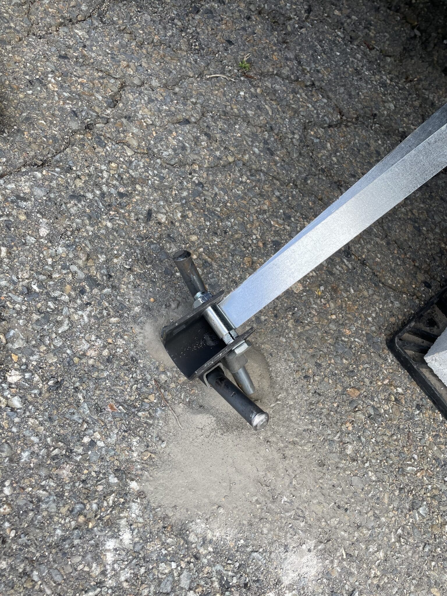 An image of a cross drive anchor with a tie-down strap.