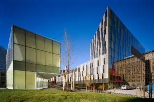 Modern modular buildings showcasing triumph modular construction with a sleek glass facade and green surroundings, representing both permanent and temporary modular building solutions.