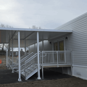 School building side view with covered walkway and stairs