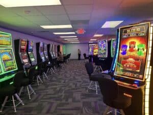 Interior photo of a modular casino that shows slot machines and chairs