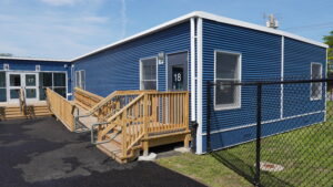Classroom building exterior view with wooden stairway