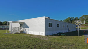 modular school building addition with existing school in background