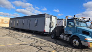 Deliver day of 24x64 modular building. Being towed into the parking lot of the city of Rochester Hills.