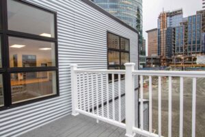 exterior of modular office building in boston showing siding and deck with downtown boston in background